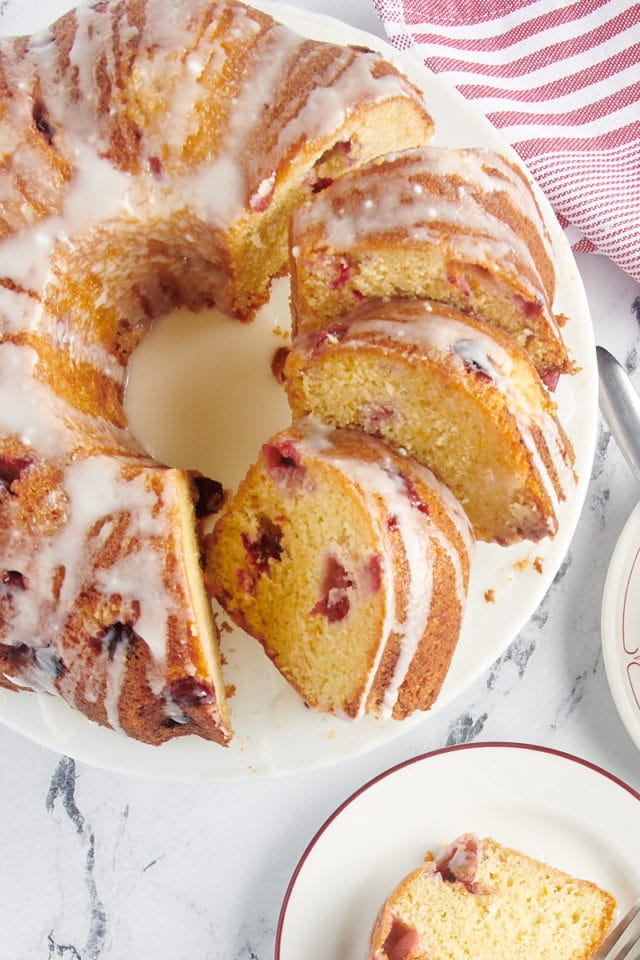 Cranberry bundt cake with slices missing.