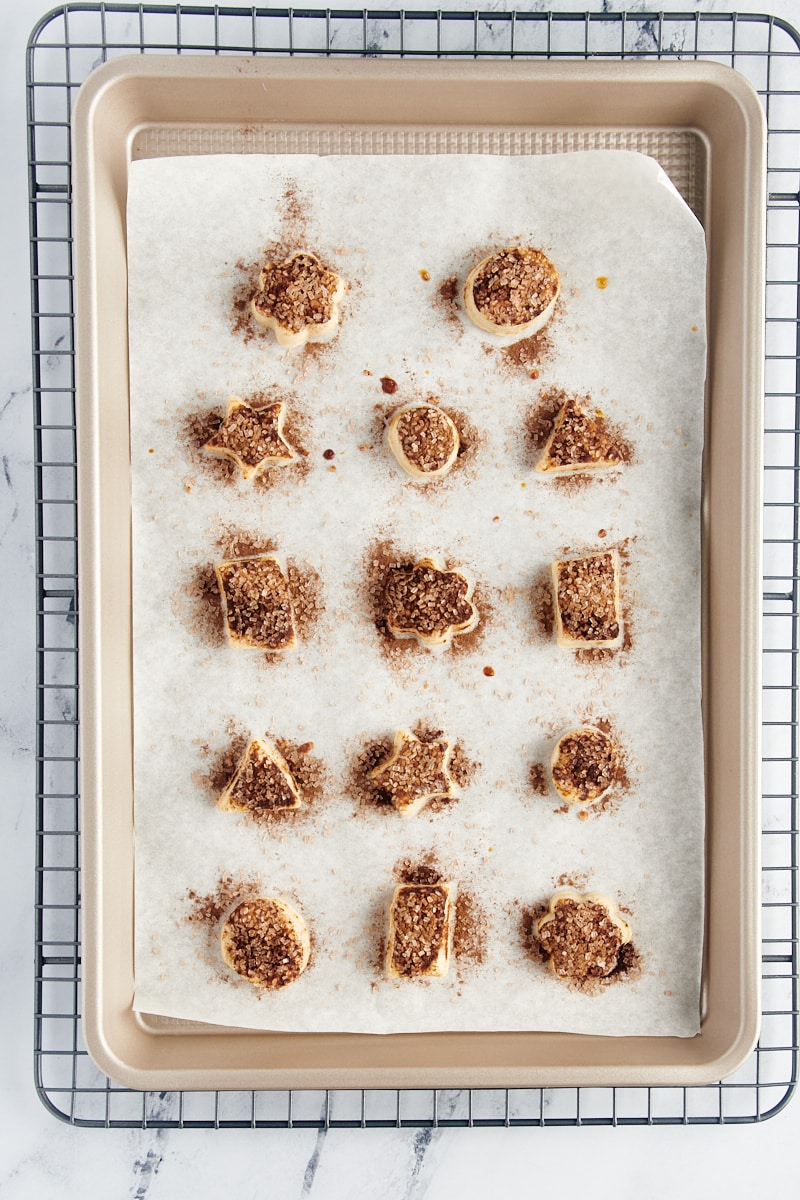overhead view of freshly baked Pie Crust Cookies on a parchment-lined sheet pan
