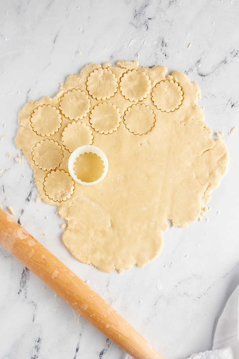 Shortbread cookie dough partially cut with a round cookie cutter.