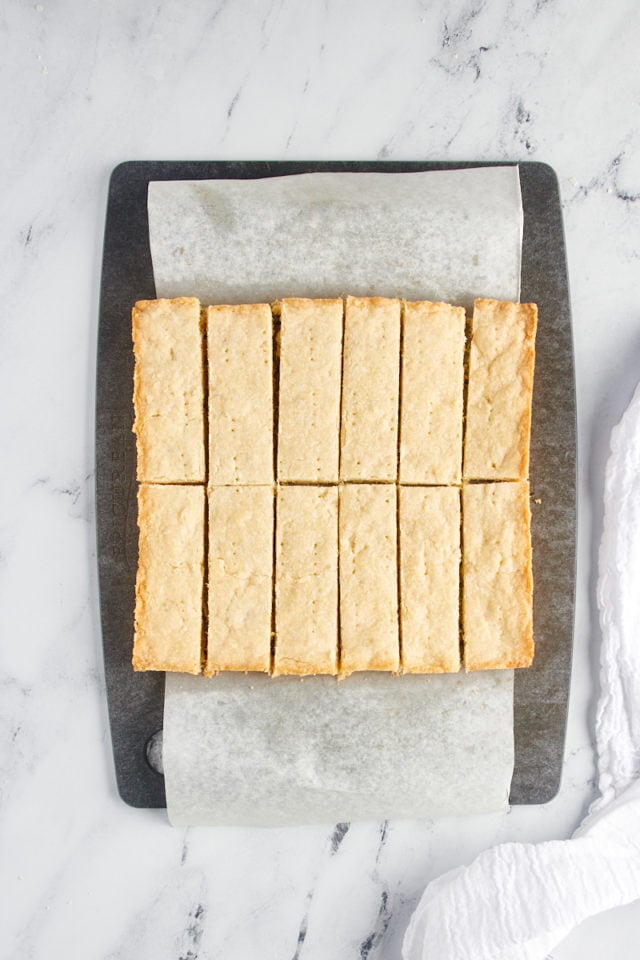 Overhead view of sliced shortbread on a cutting board.