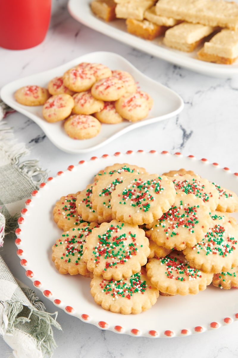 Shortbread cookies arranged on three white plates.