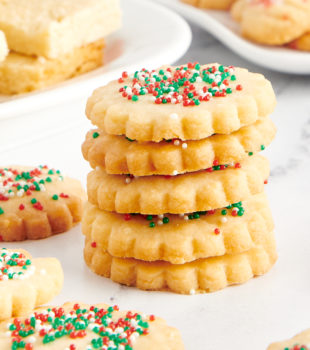 stack of shortbread cookies surrounded by more cookies