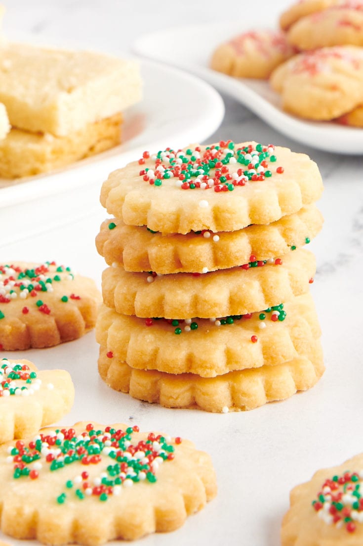 stack of shortbread cookies surrounded by more cookies