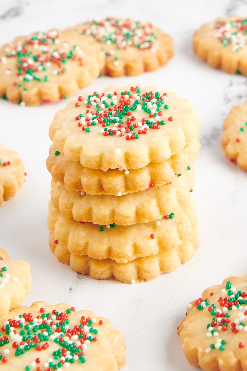 Stack of shortbread cookies with more cookies surrounding them.