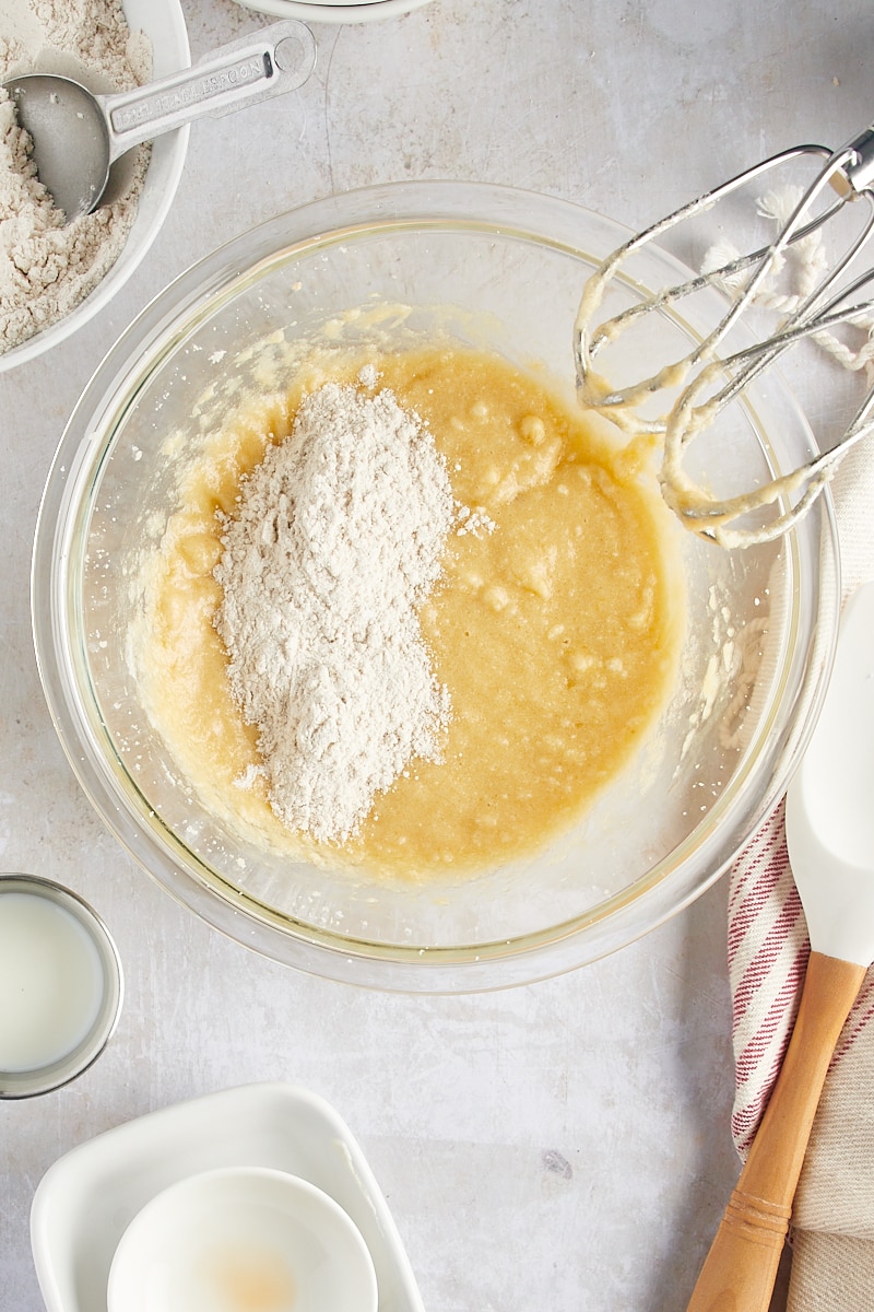 overhead view of dry ingredients added to spice cake batter