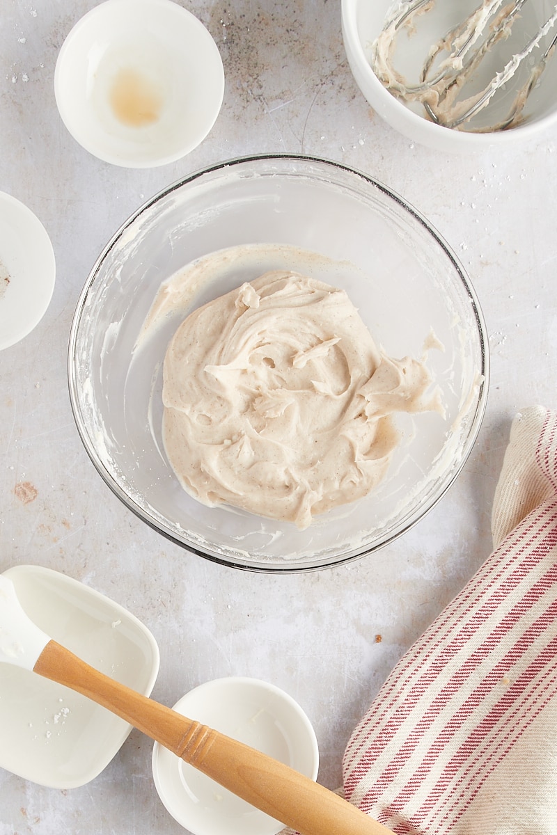 overhead view of cinnamon cream cheese frosting in a glass mixing bowl