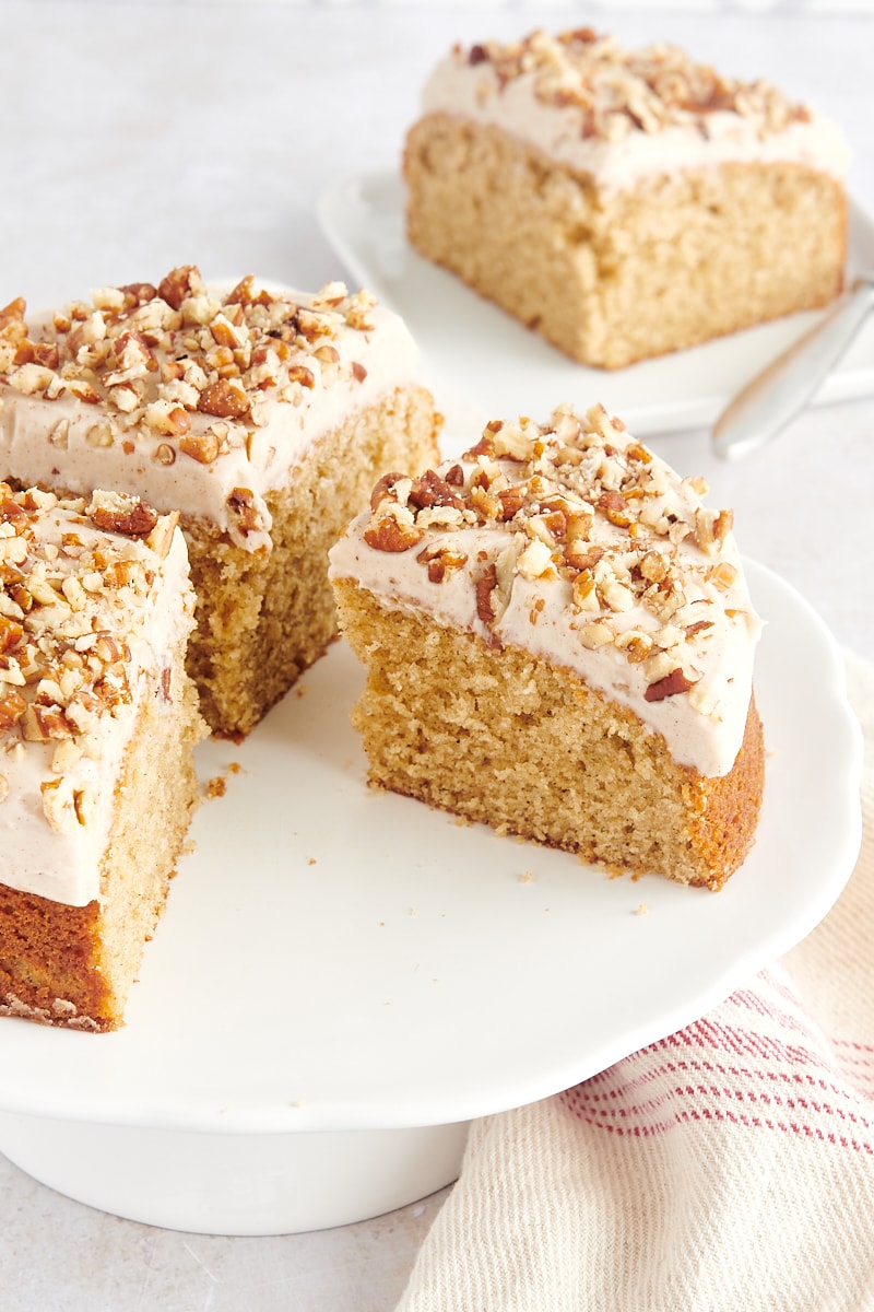 partially sliced spice cake on a white cake stand