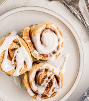overhead view of three Biscuit Cinnamon Rolls on a white plate