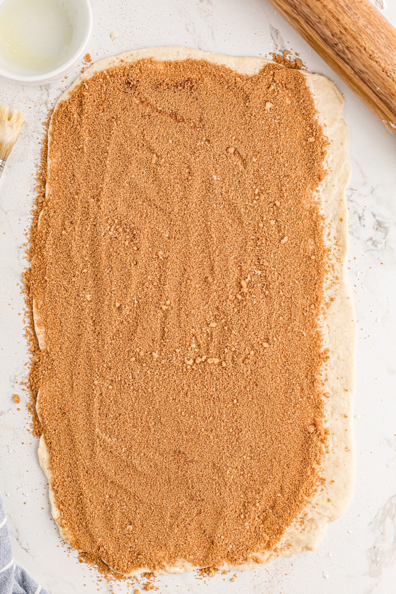 Dusting the dough with cinnamon sugar