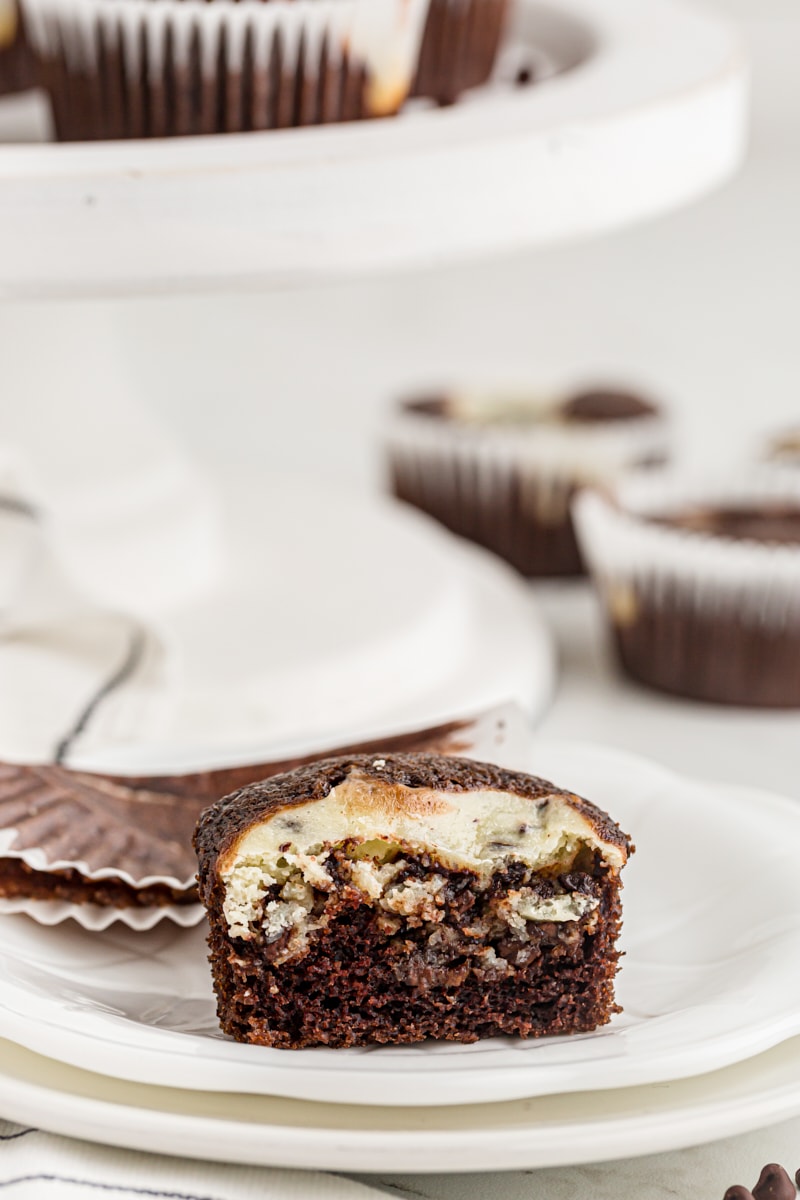 half of a Black Bottom Cupcake on a white plate