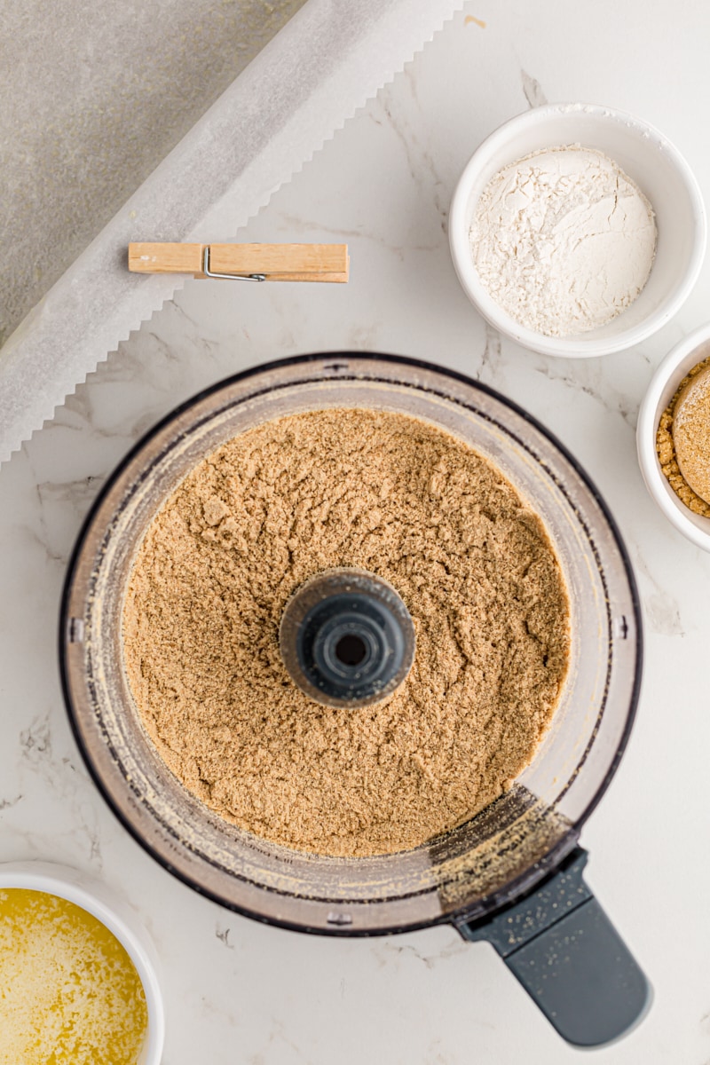 overhead view of graham cracker crumbs in a food processor