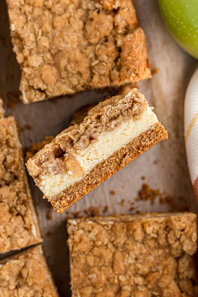 overhead view of sliced Caramel Apple Cheesecake Bars on parchment paper