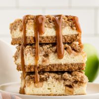 stack of three Caramel Apple Cheesecake Bars on a white plate
