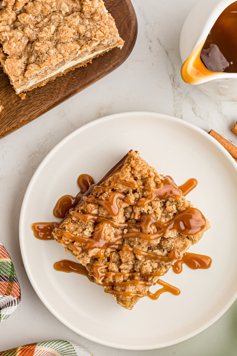 overhead view of a Caramel Apple Cheesecake Bar on a white plate