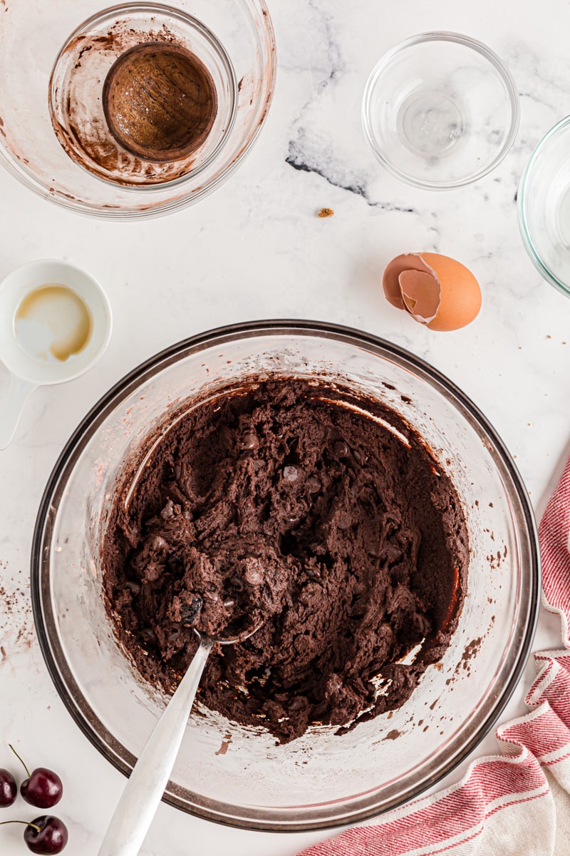 Chocolate cookie dough in glass mixing bowl