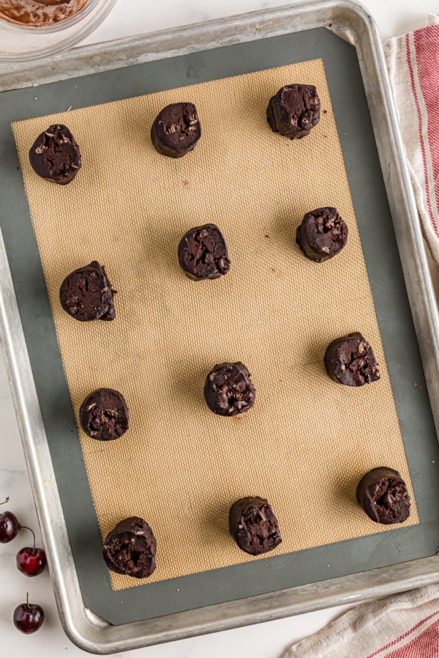 Chocolate cherry cookies on a baking sheet, before baking.