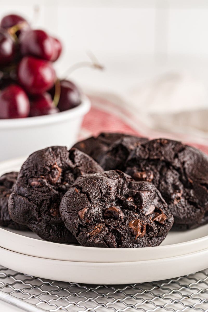 Chocolate cherry cookies on a white plate.