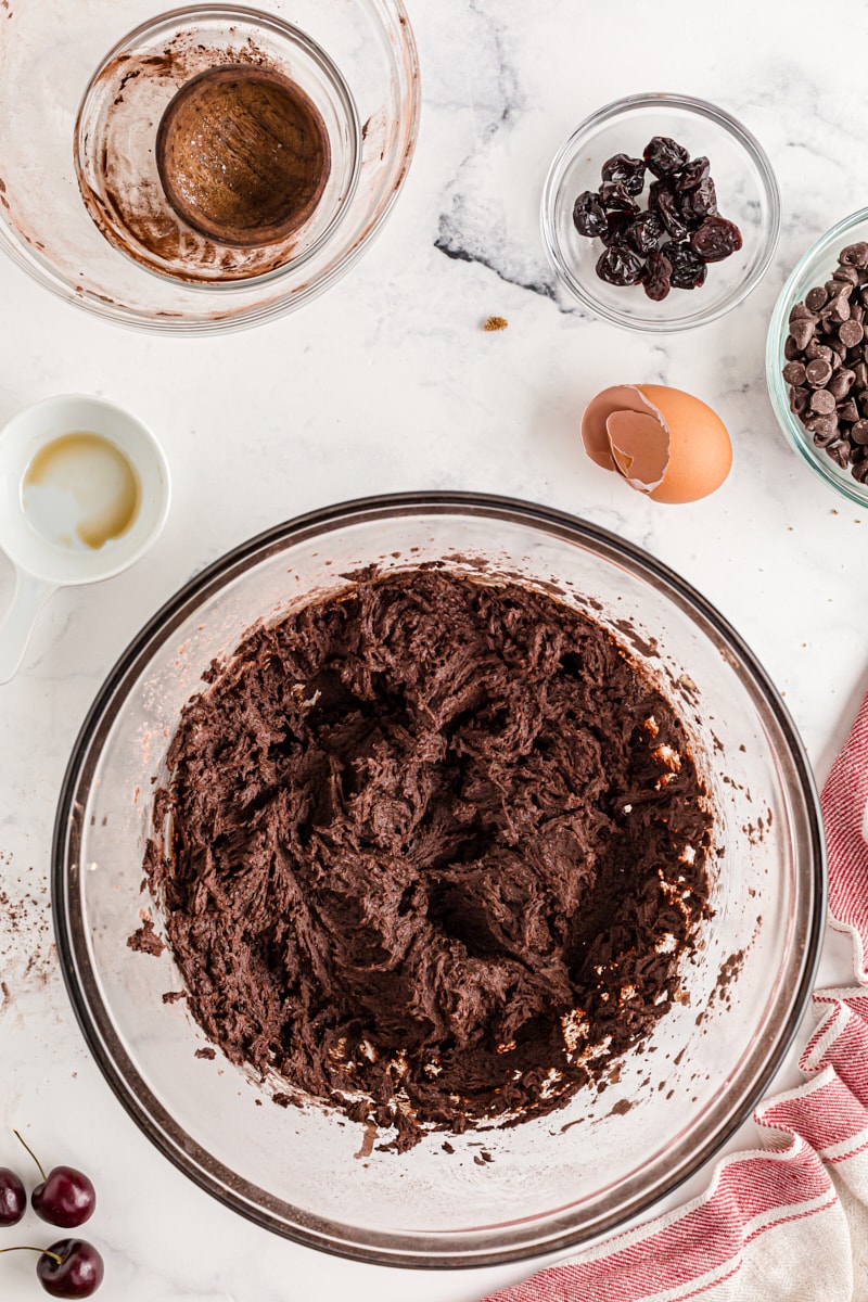 Chocolate cookie dough in glass mixing bowl