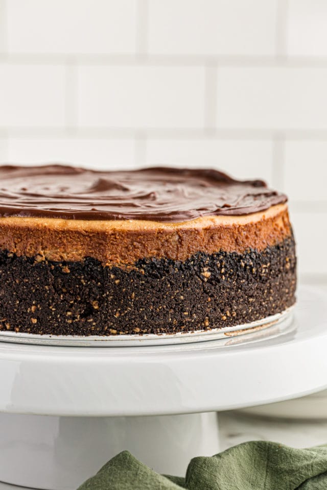 Peanut butter cup cheesecake on a cake stand.