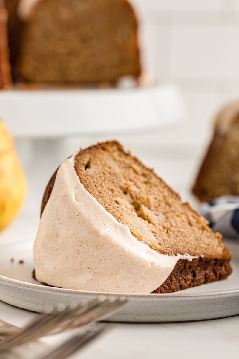 A slice of pear cake on a white plate