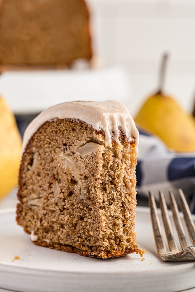 a partial slice of pear cake on a white plate