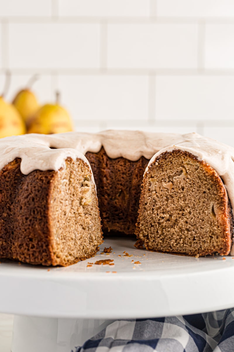 partially sliced Spiced Pear Cake on a white cake stand