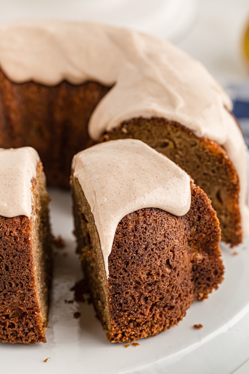 A slice being taken out of glazed spiced pear cake