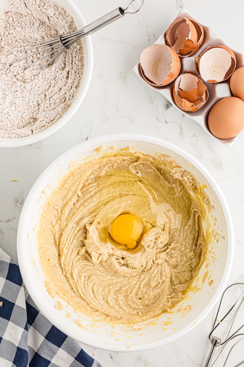 Adding eggs to the cake batter