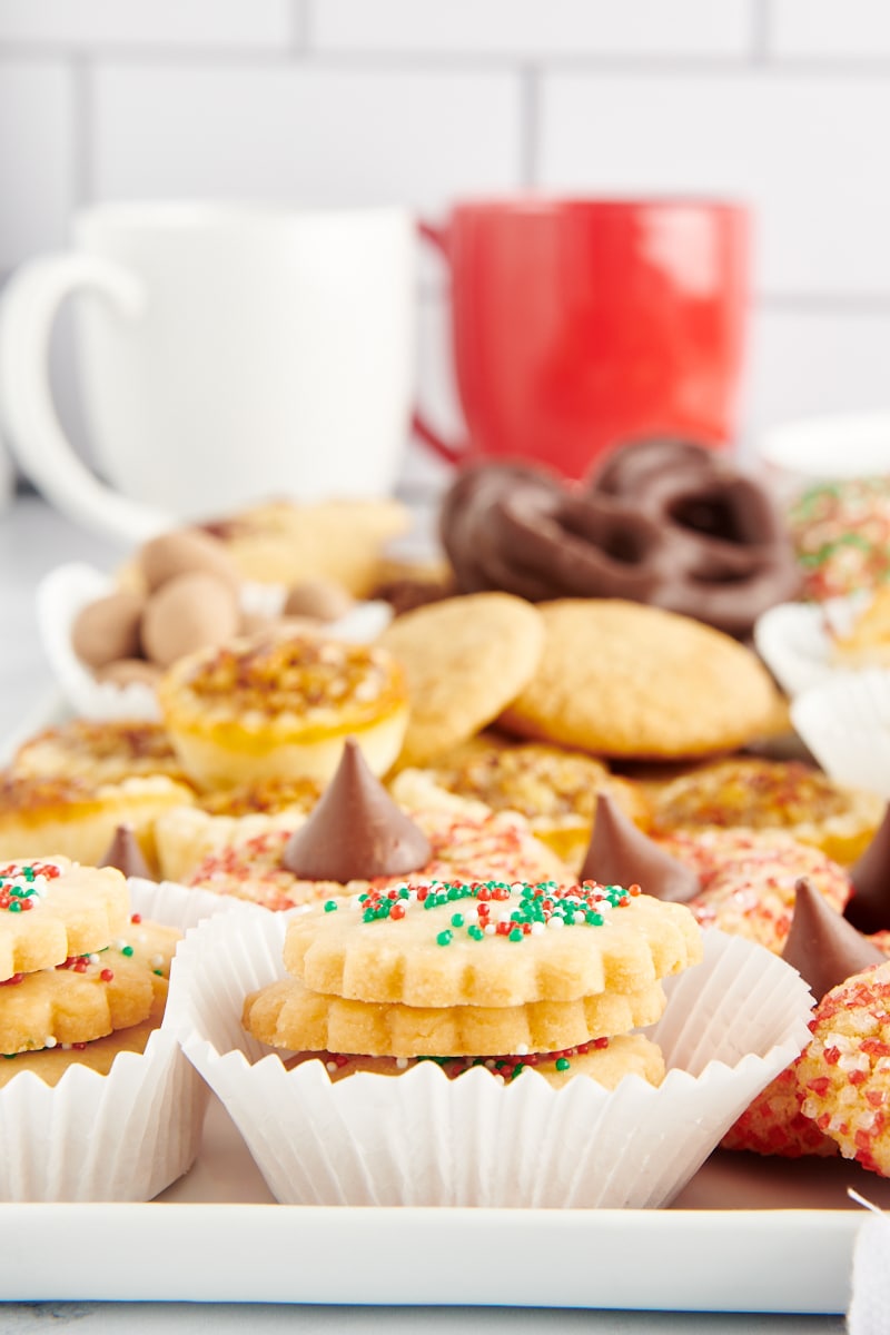 various Christmas cookies on a white tray