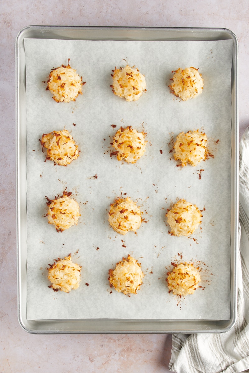 overhead view of freshly baked Coconut Macaroons on a parchment-lined baking sheet