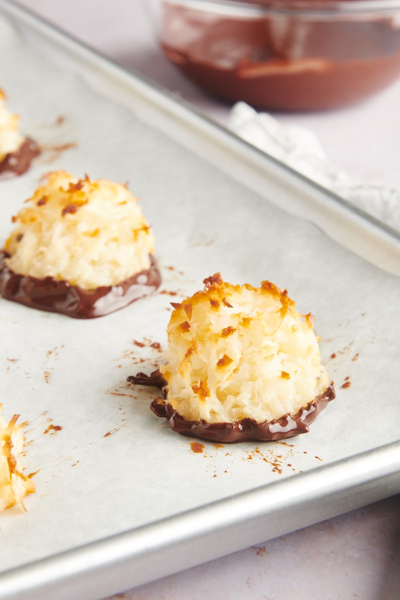 a few Coconut Macaroons freshly dipped in melted chocolate and placed on parchment paper