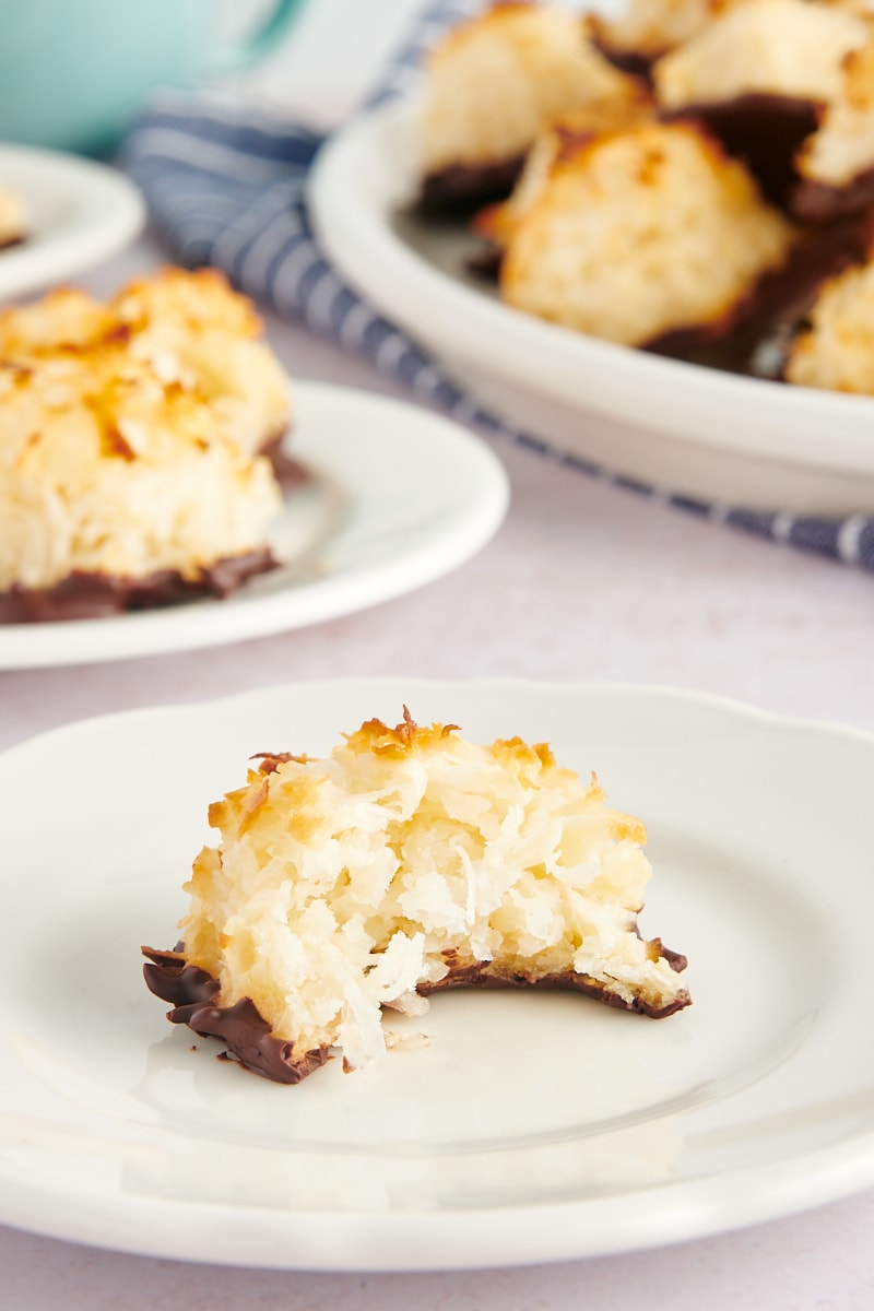 a Coconut Macaroon on a white plate with a bite missing