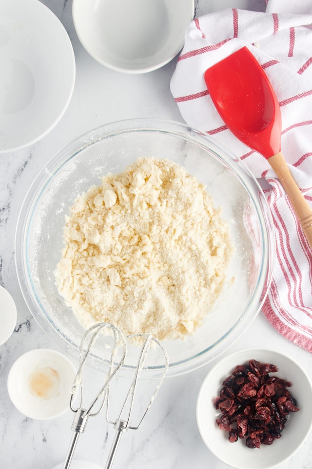 overhead view of mixed shortbread dough in a glass mixing bowl