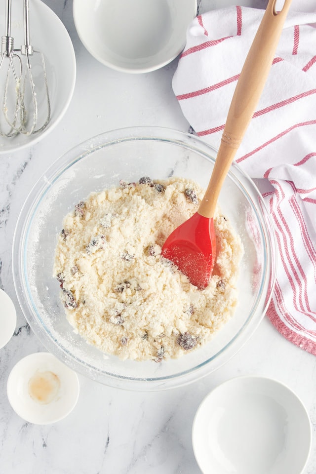 overhead view of mixed Cranberry Shortbread Cookie dough in a glass mixing bowl