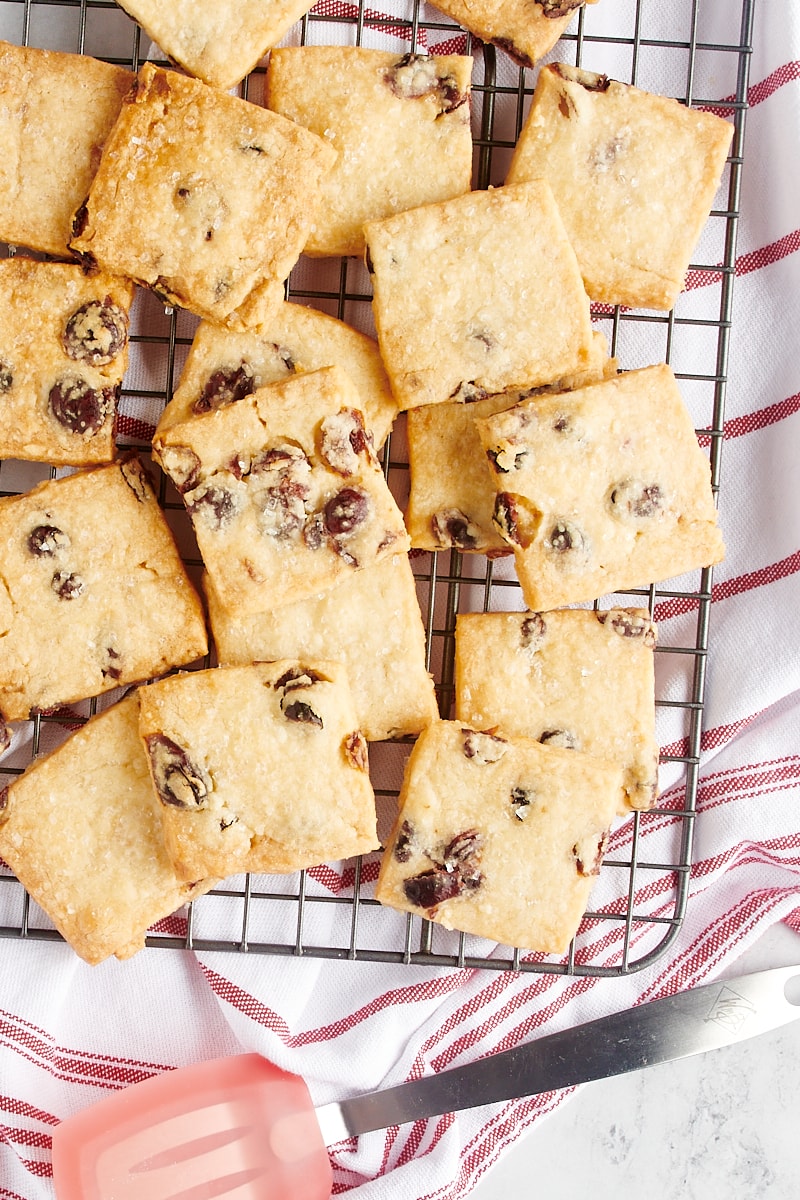 Overhead view of cranberry shortbread cookies on a wire cooling rack.