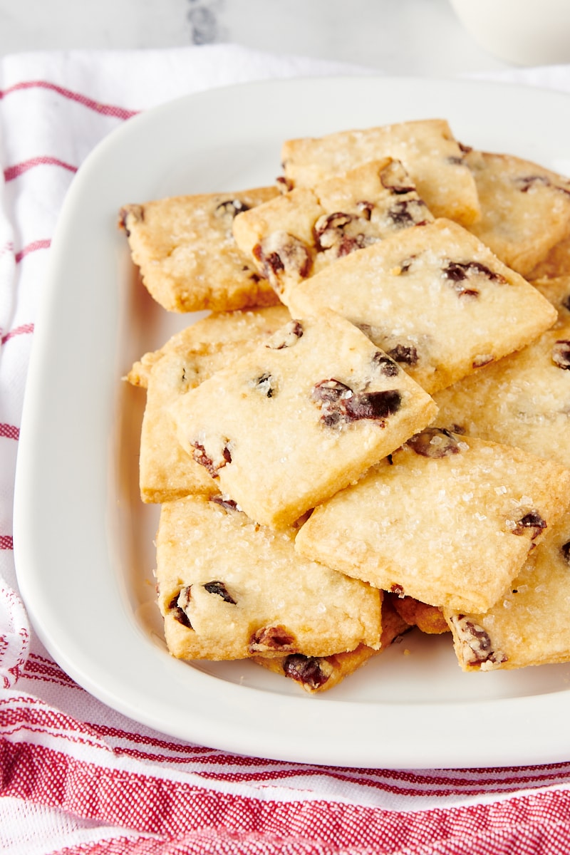 Cranberry shortbread cookies served on a rectangular white plate.