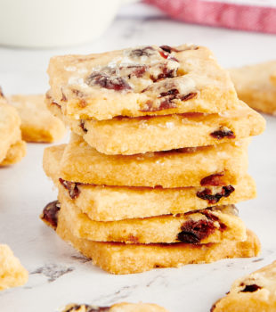 stack of Cranberry Shortbread Cookies with more cookies surrounding the stack