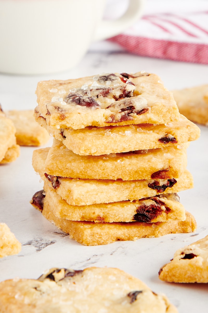 stack of Cranberry Shortbread Cookies with more cookies surrounding the stack