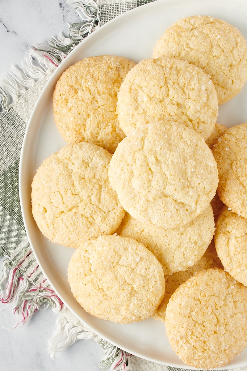 Overhead view of sugar cookies on a white plate.