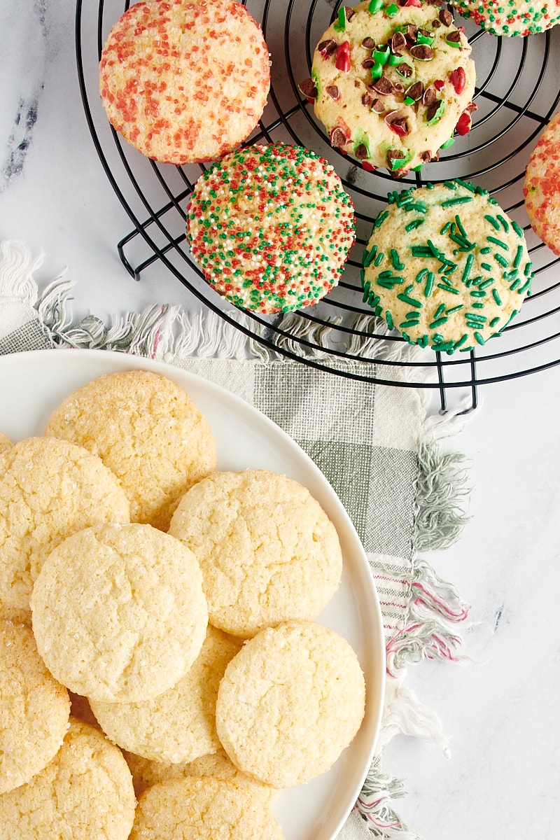 Sugar cookies on a wire rack and a large white plate.