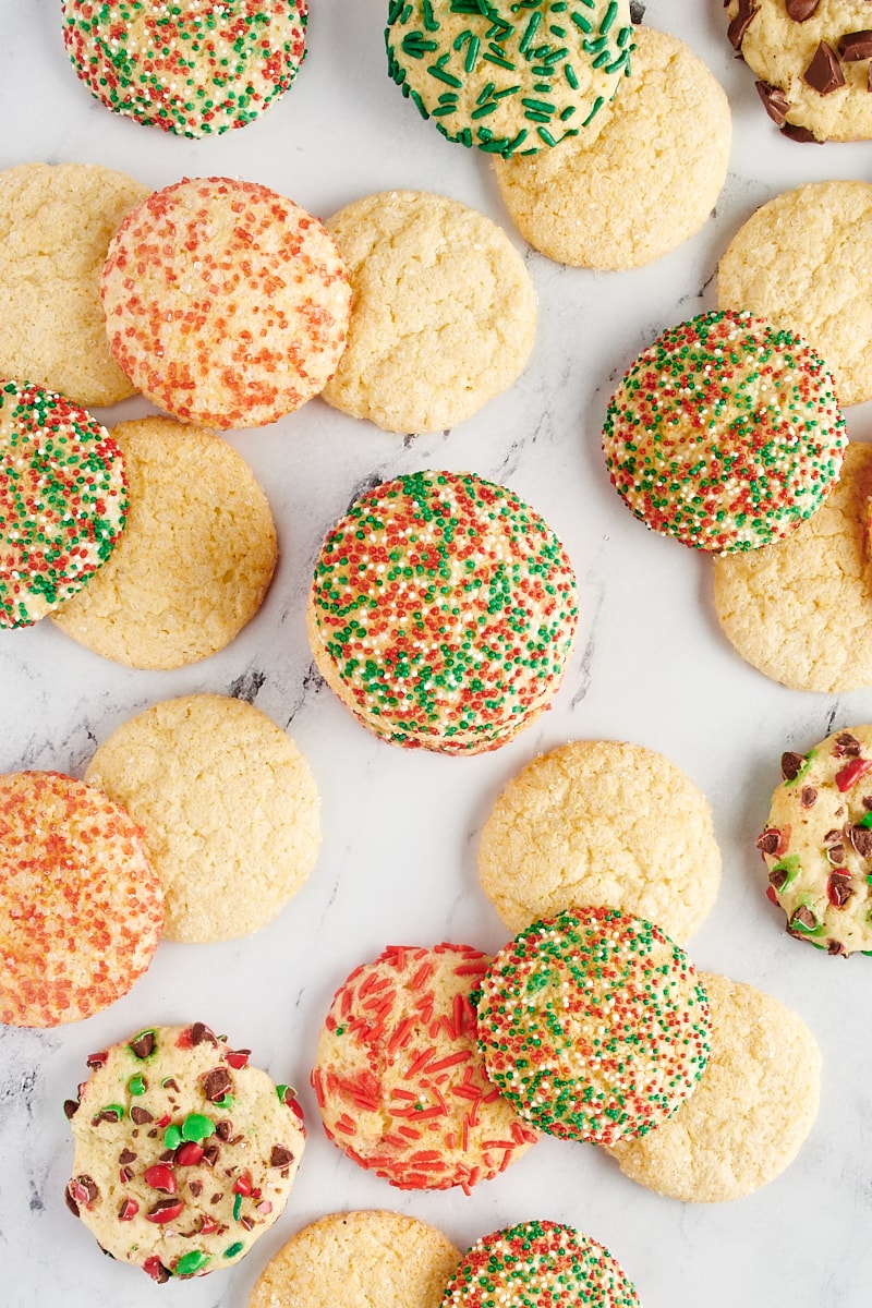 Various sugar cookies scattered over a marble surface.