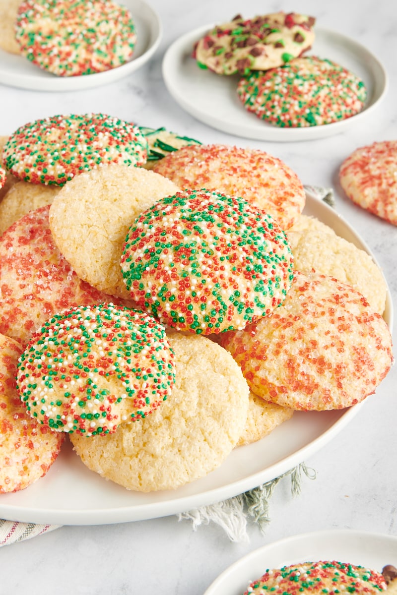 differently decorated sugar cookies piled on a large white plate