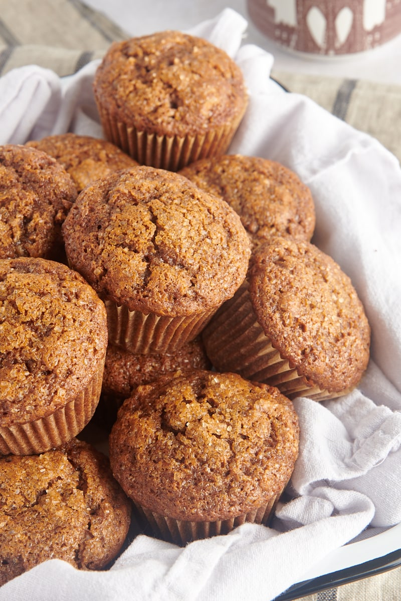 Gingerbread Muffins piled on a cloth-lined tray