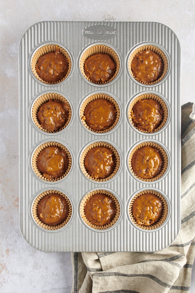 overhead view of Gingerbread Muffin batter in a muffin pan