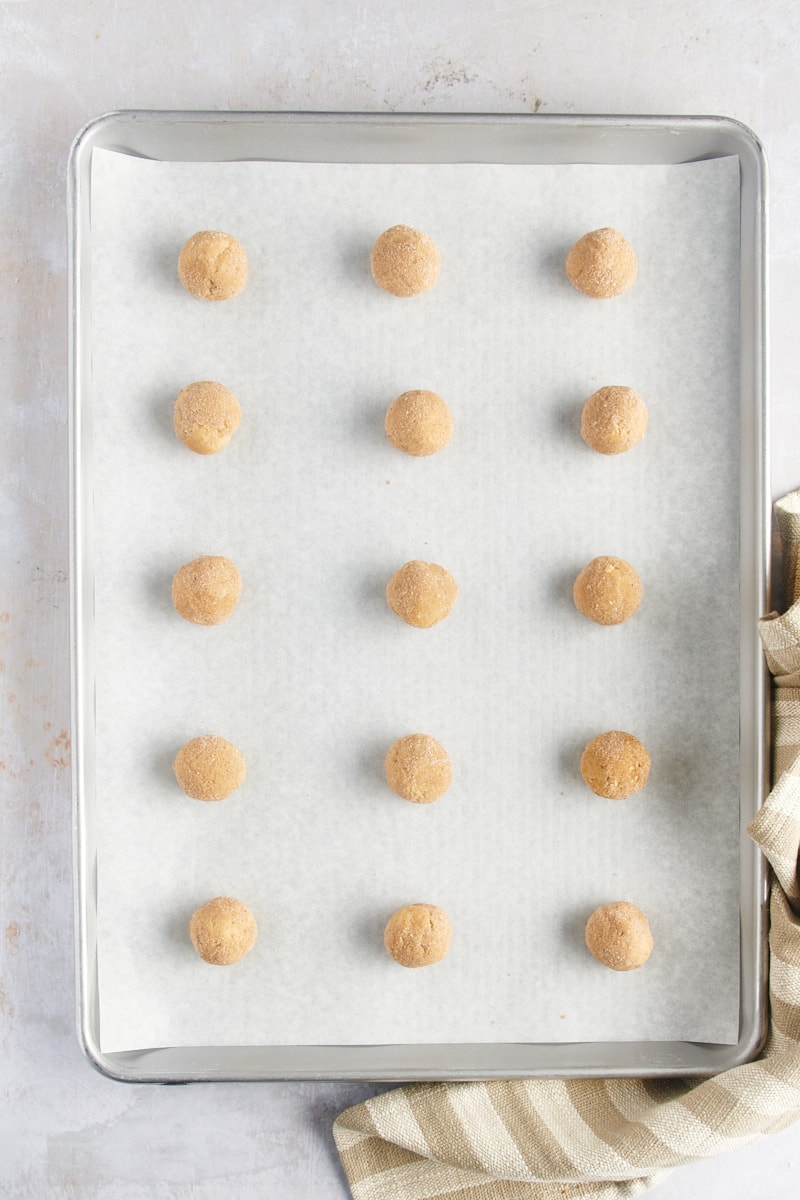 overhead view of portioned Gingerdoodle Cookies on a parchment-lined baking sheet ready for the oven