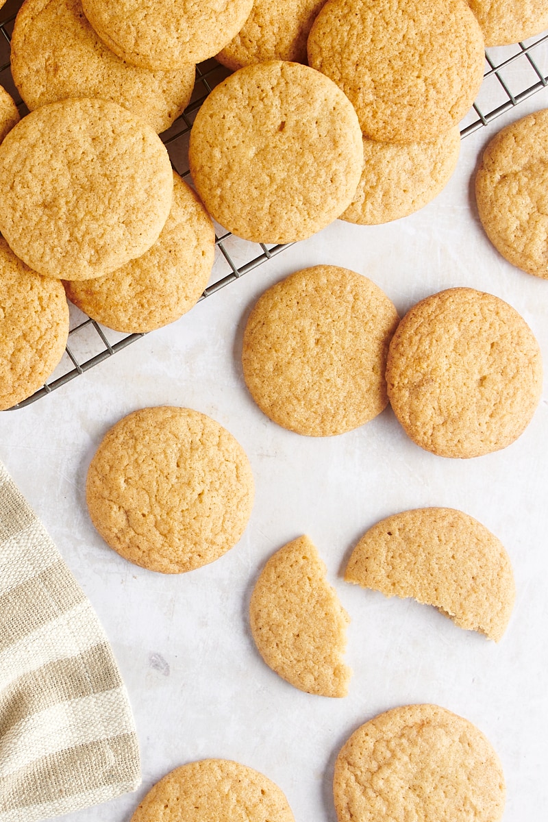 overhead view of Gingerdoodle Cookies scattered on a countertop and on a wire rack