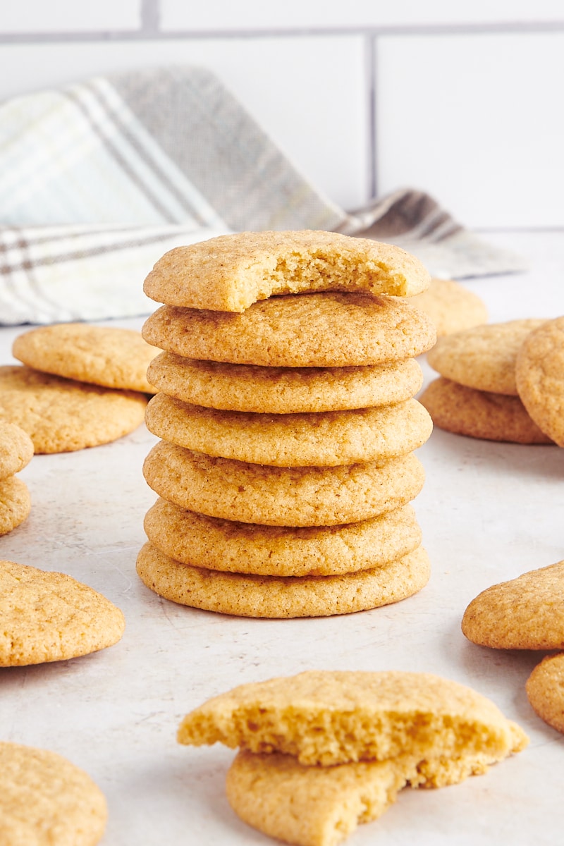 six gingerdoodle cookies stacked with another cookie on top with a bite missing