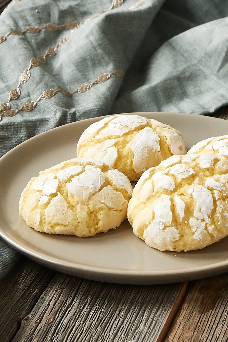 Four Key lime crinkle cookies on plate with napkin in background