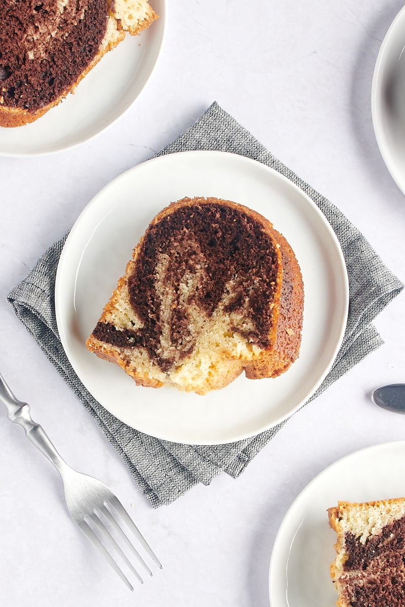 overhead view of a slice of Marble Bundt Cake on a white plate