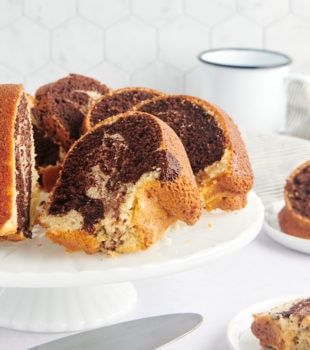 sliced Marble Bundt Cake on a white cake stand